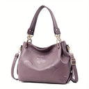 Purple handbag with floral design on a white background